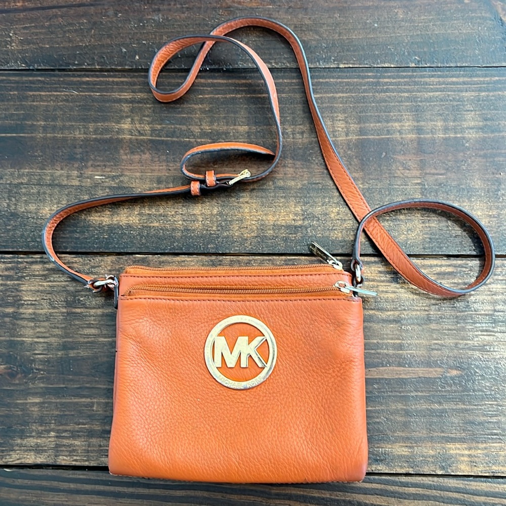 Micheal Kors travel purse with strap.